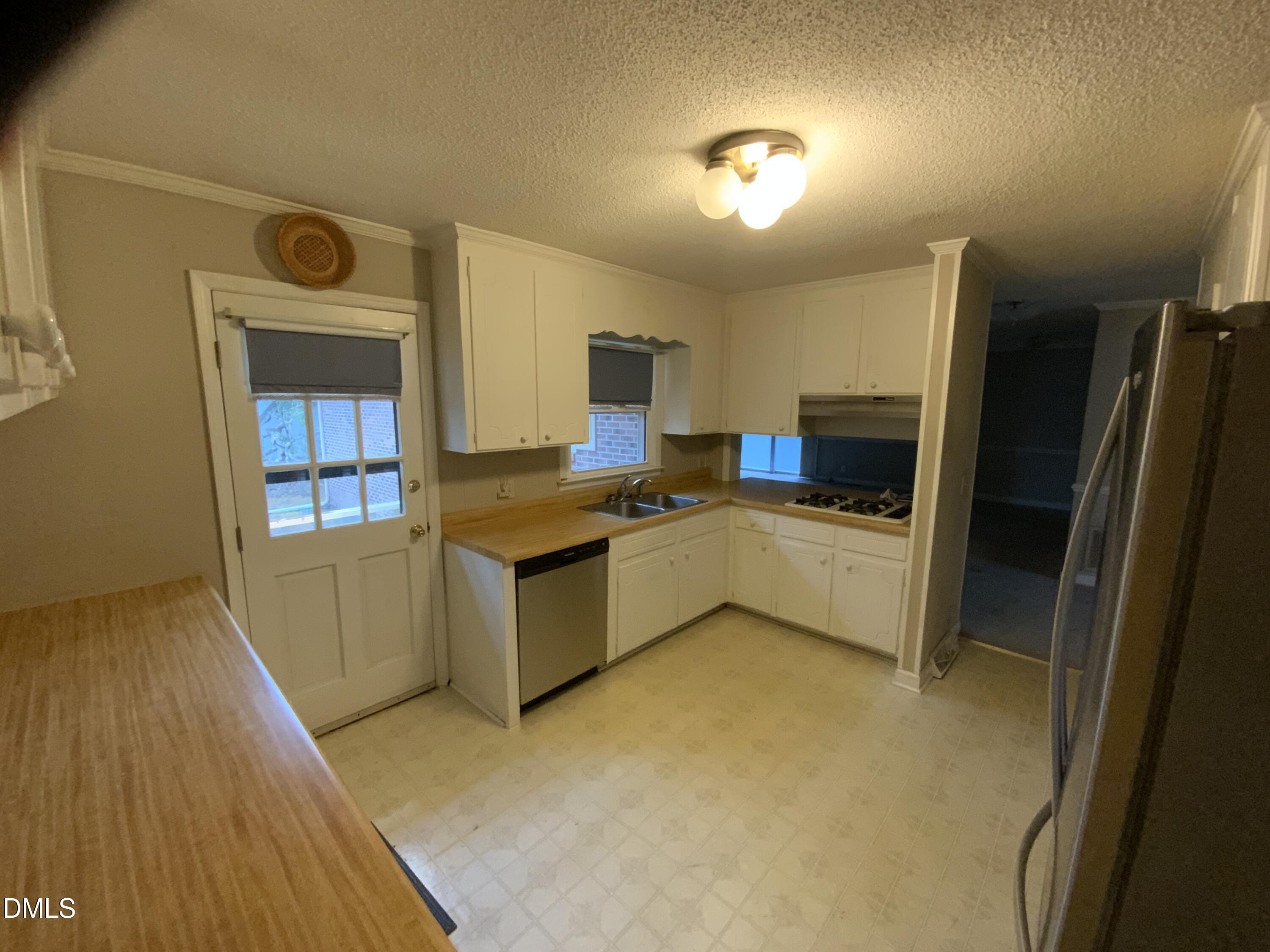 100 East C Street Erwin, NC 28339 - Photo 2 of 21 a kitchen with stainless steel appliances a refrigerator and a stove
