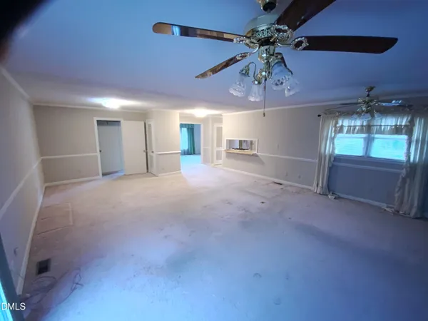 a view of a livingroom with a ceiling fan and window
