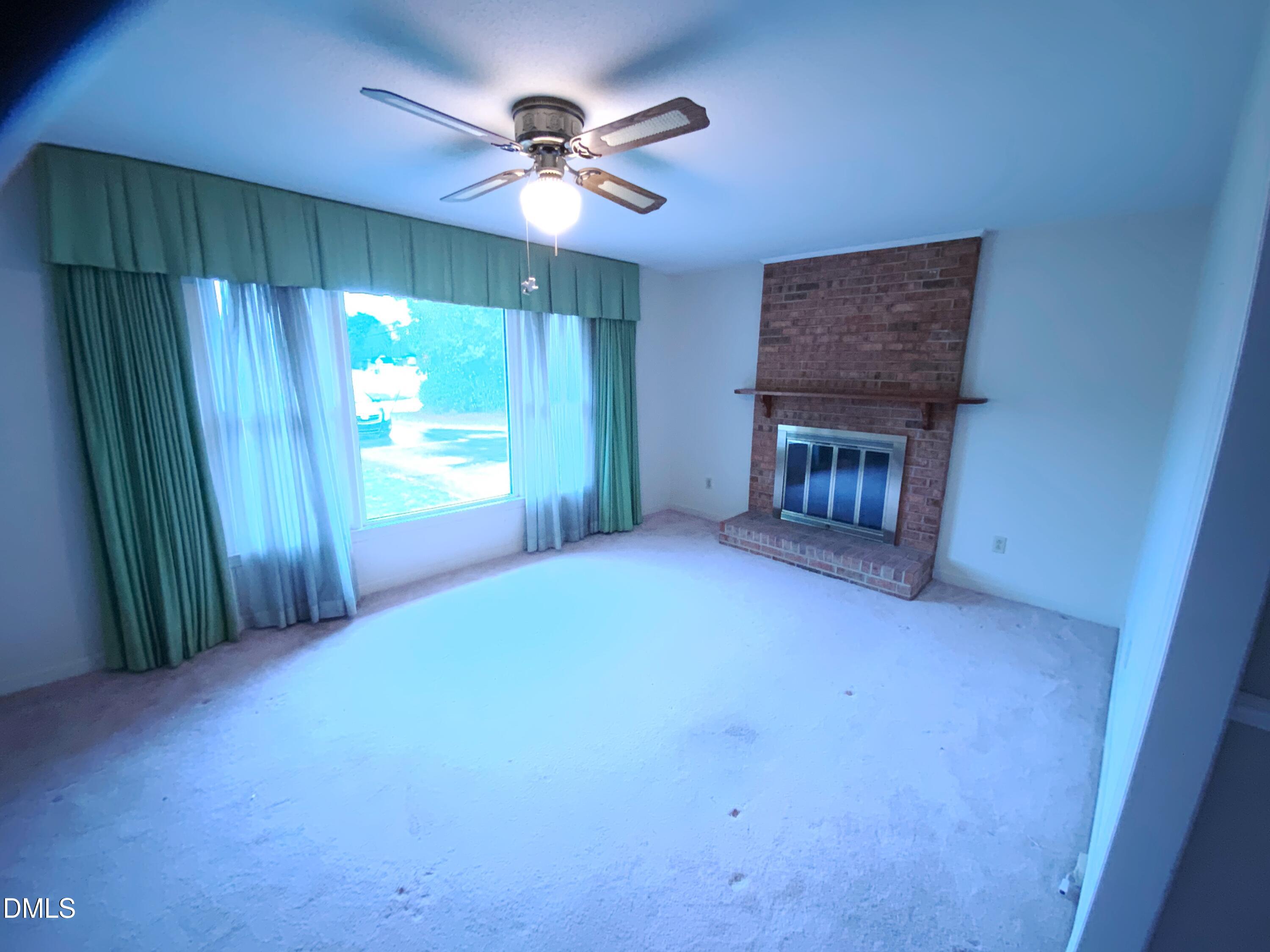 100 East C Street Erwin, NC 28339 - Photo 6 of 21 a view of empty room with a fireplace and fan