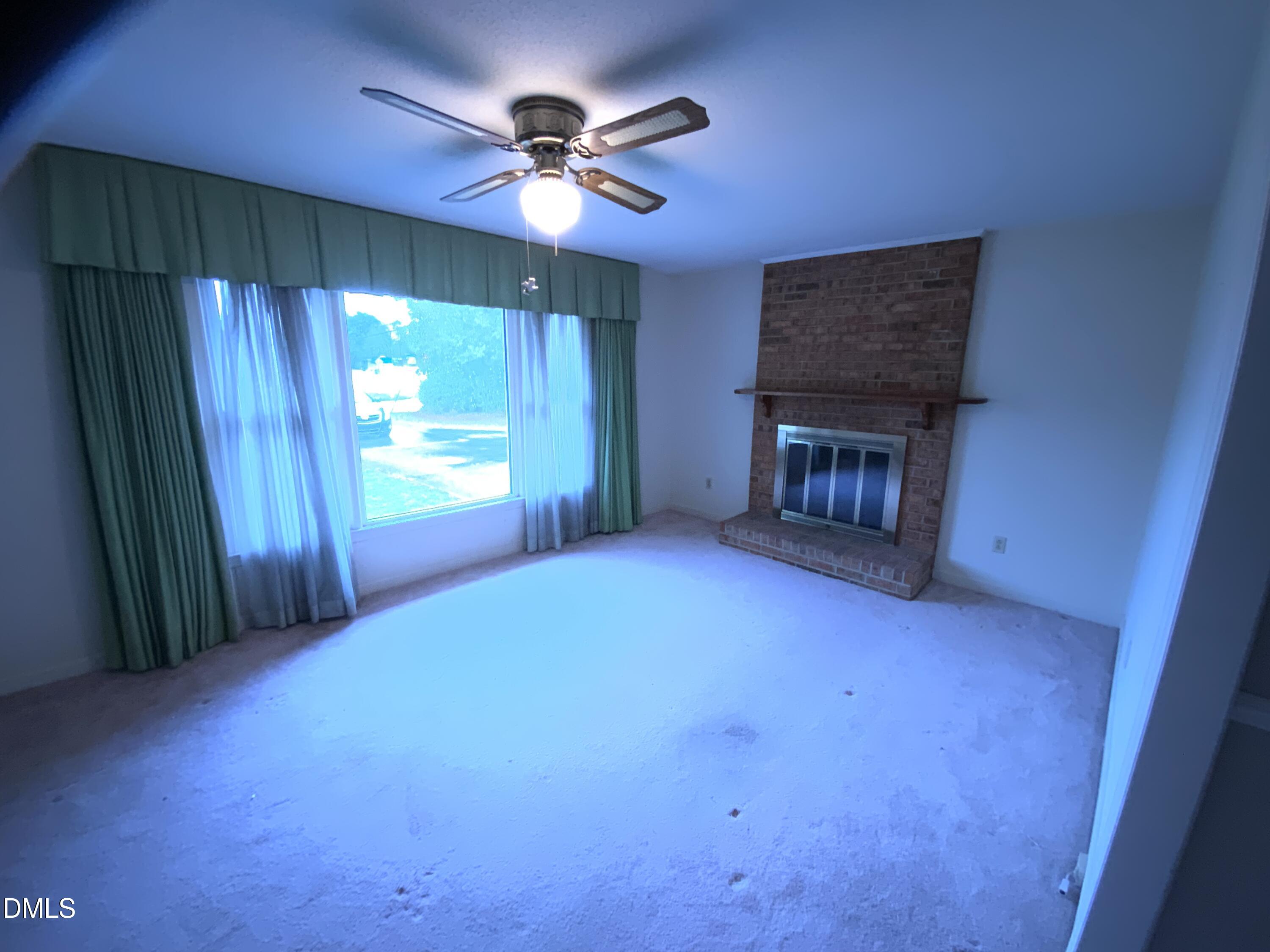 100 East C Street Erwin, NC 28339 - Photo 7 of 21 a view of empty room with a fireplace and fan