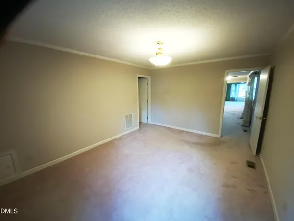 an empty room with windows and entrance