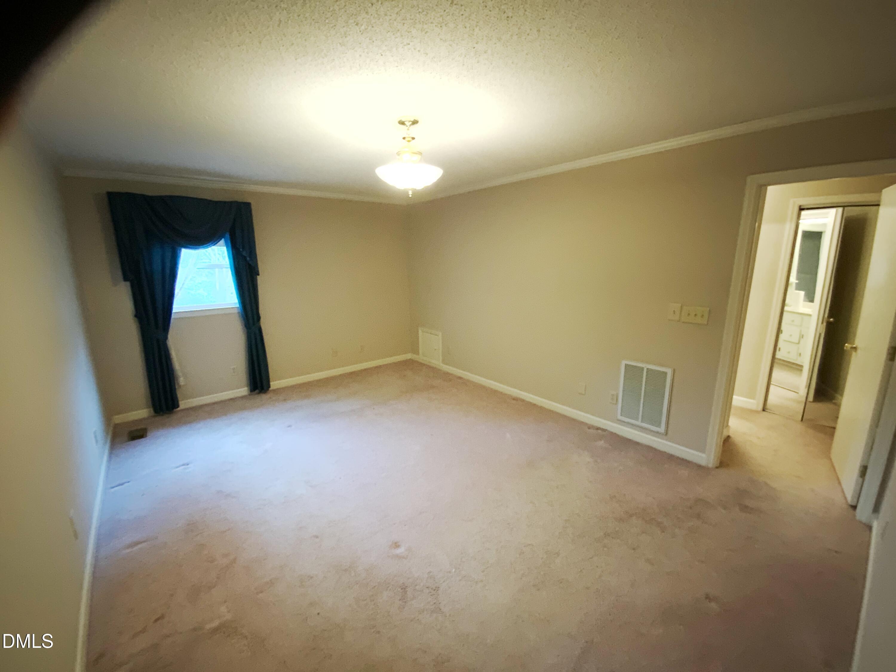 100 East C Street Erwin, NC 28339 - Photo 10 of 21 an empty room with a mirror and a window