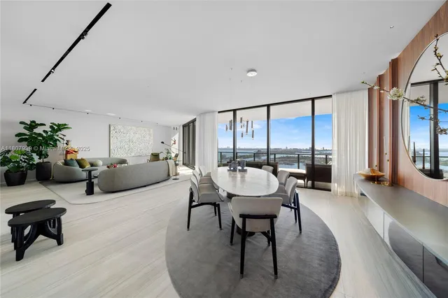 a living room with furniture and a floor to ceiling window