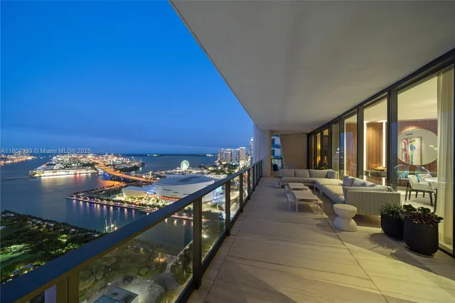 a living room with furniture and a painting on the wall