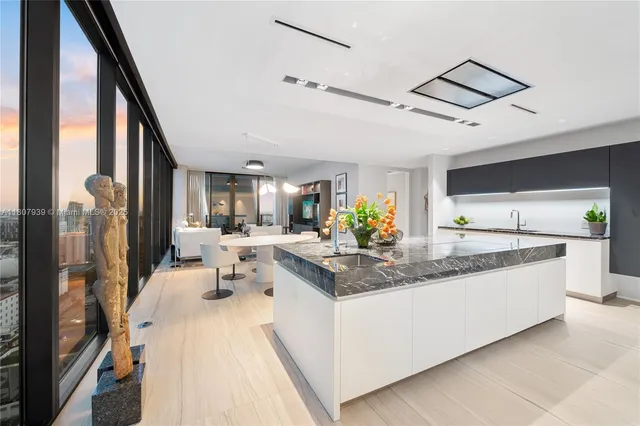 a living room with furniture and a floor to ceiling window