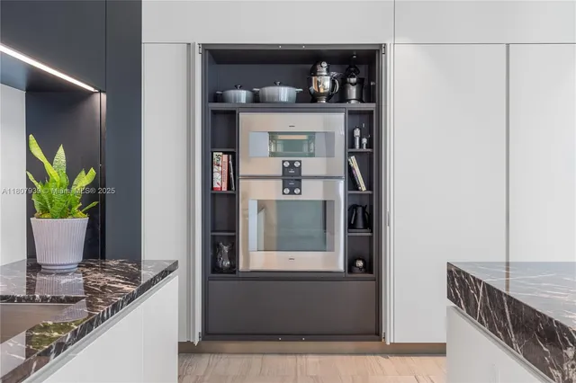 a spacious bedroom with a large bed and a chandelier