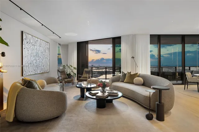 a living room with furniture flowerpot and wooden floor