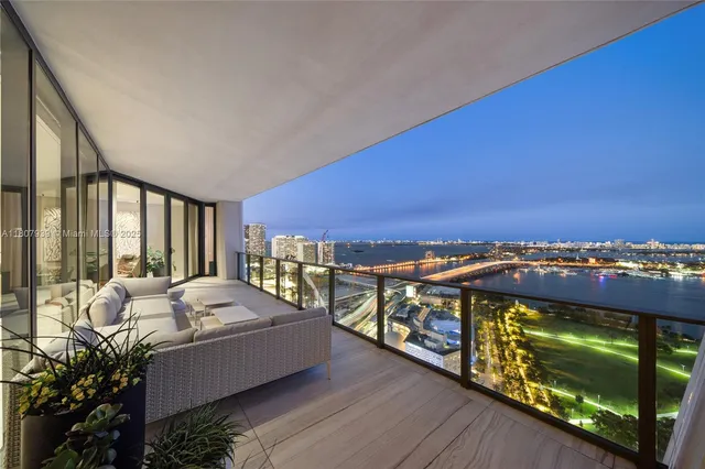 a living room with granite countertop furniture and a flat screen tv