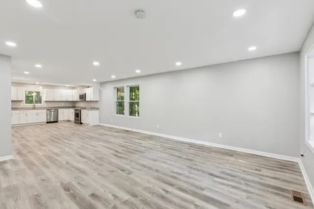 a view of kitchen with kitchen island and wooden floor