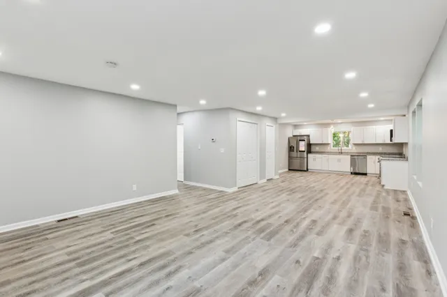 a view of an empty room with wooden floor