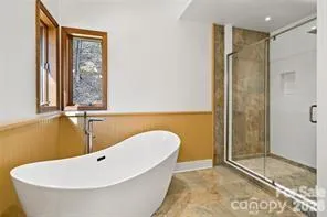 a bathroom with a bathtub and shower