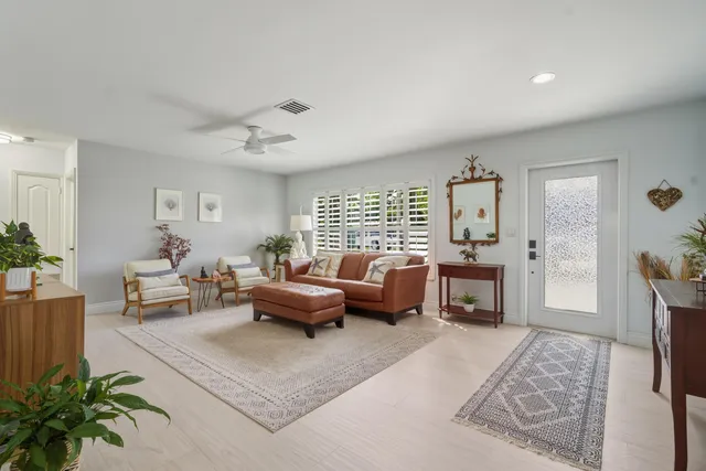 a living room with furniture a large window and a flat screen tv