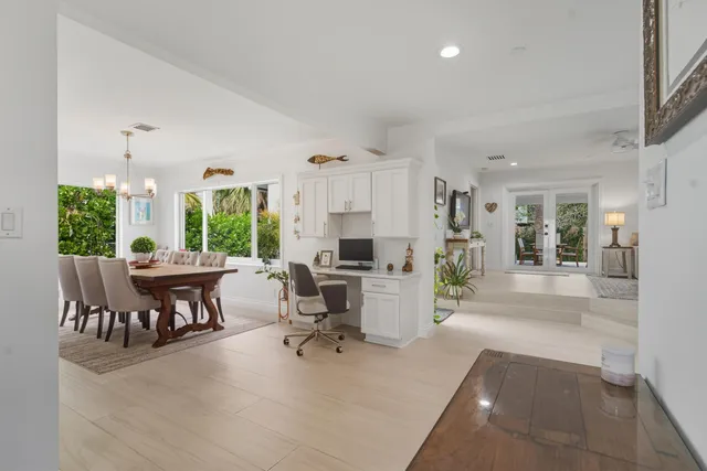 a kitchen with a refrigerator and a dining table