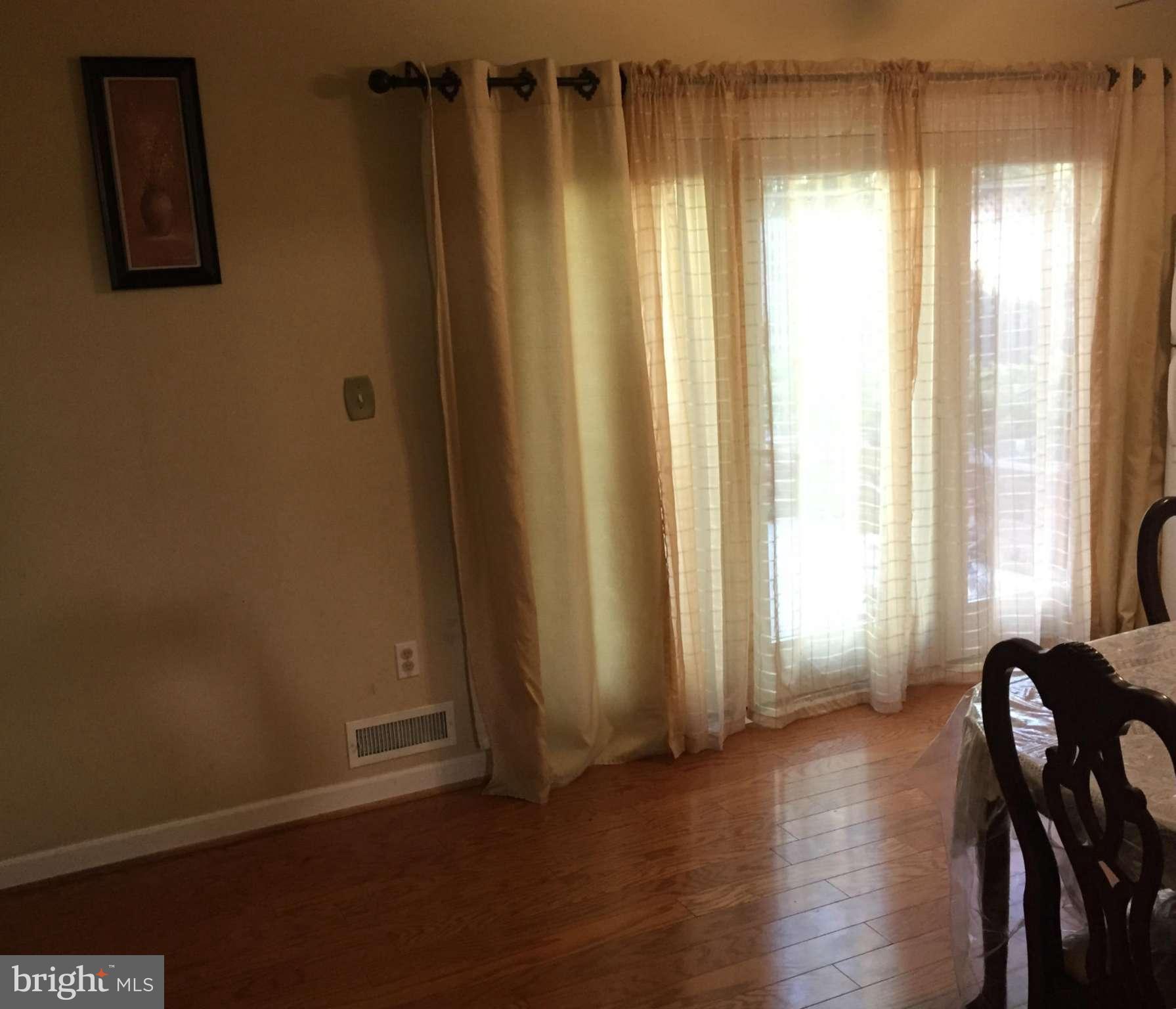 12905 Dean Road Silver Spring, MD 20906 - Photo 7 of 8 a view of a room with wooden floor and windows