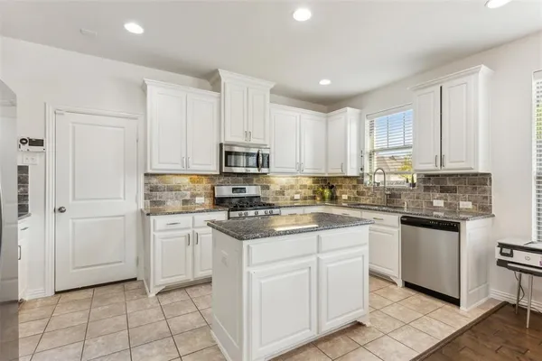 a kitchen with lots of counter top space and dining table
