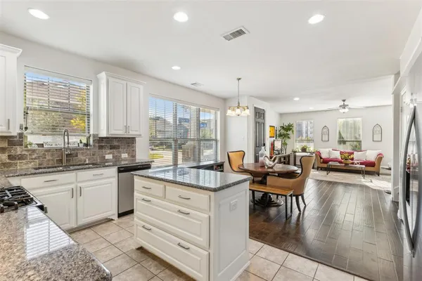 a living room with kitchen island furniture and a chandelier