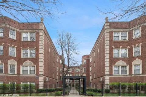 a front view of a residential apartment building with a yard