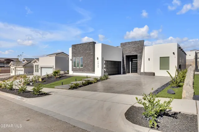 a front view of a house with a yard and outdoor seating