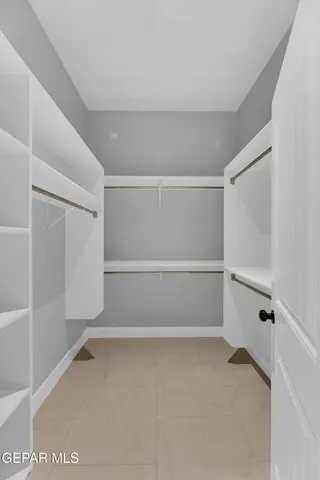 a spacious bathroom with a double vanity sink toilet mirror and shower