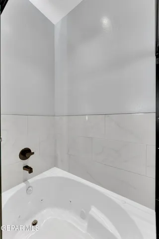 a view of an empty room with a fireplace and a window