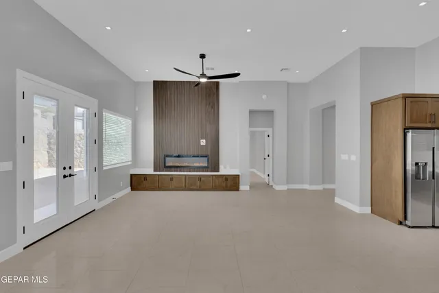 a kitchen with stainless steel appliances granite countertop a sink a stove and a refrigerator