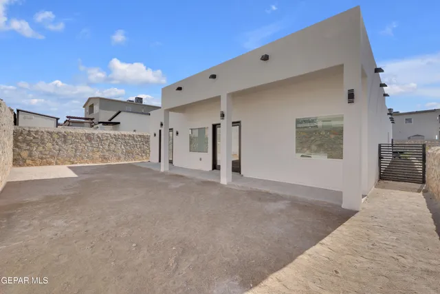 an aerial view of a building with outdoor space and ocean view