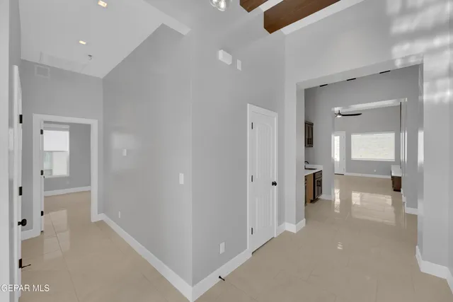 an empty room with a window and a fan