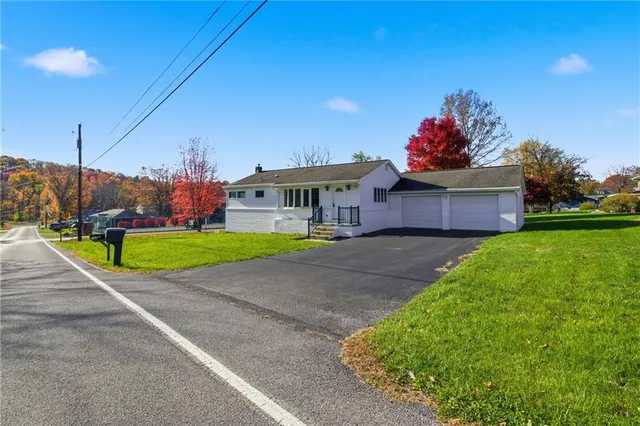 a view of a house with a yard and a fence