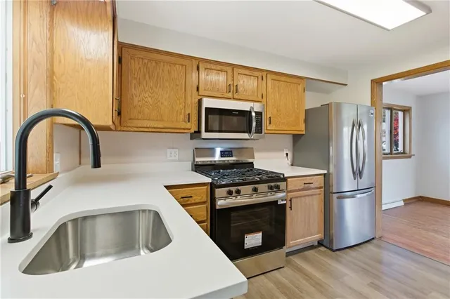 a kitchen with a stove a sink and a refrigerator