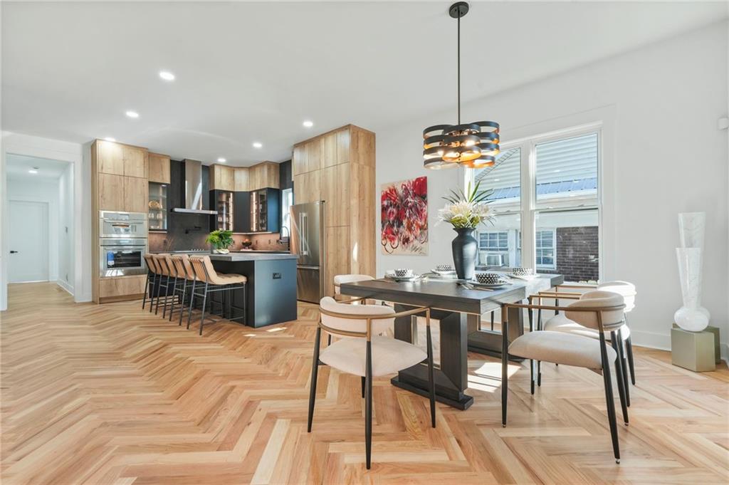 718 Cascade Avenue Southwest Atlanta, GA 30310 - Photo 12 of 37 a room with stainless steel appliances kitchen island granite countertop furniture and a wooden floor