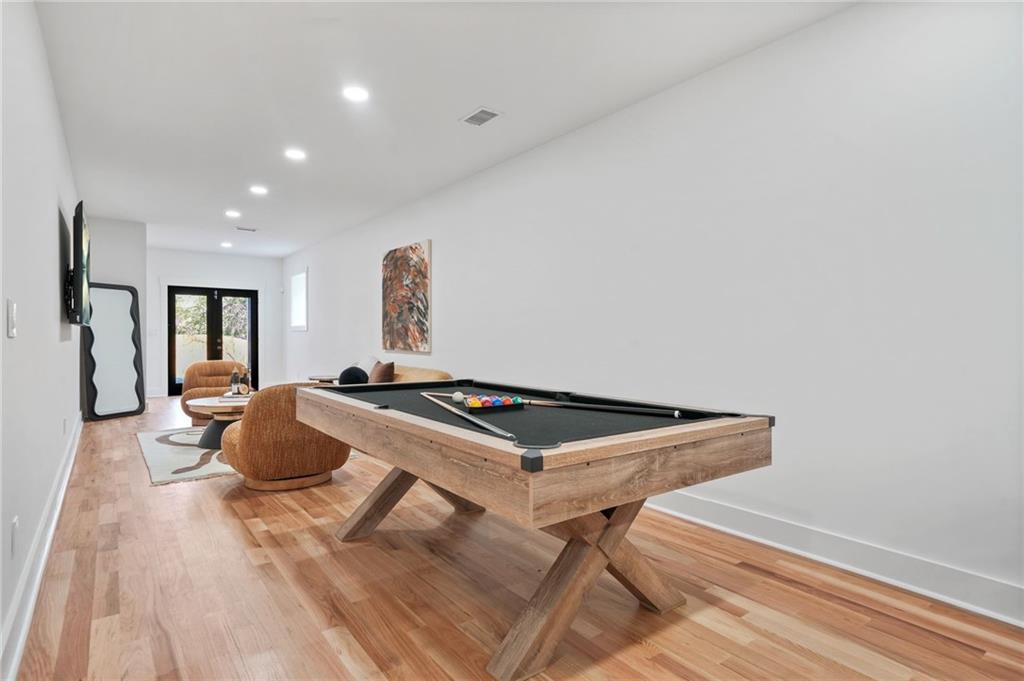 718 Cascade Avenue Southwest Atlanta, GA 30310 - Photo 22 of 37 a bedroom with a bed and wooden floor