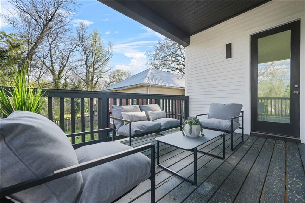 718 Cascade Avenue Southwest Atlanta, GA 30310 - Photo 28 of 37 a balcony with wooden floor and furniture