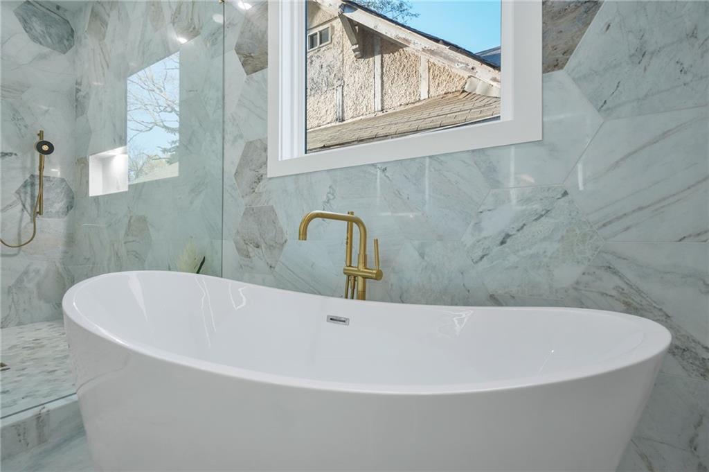 718 Cascade Avenue Southwest Atlanta, GA 30310 - Photo 30 of 37 a white bath tub sitting next to a shower
