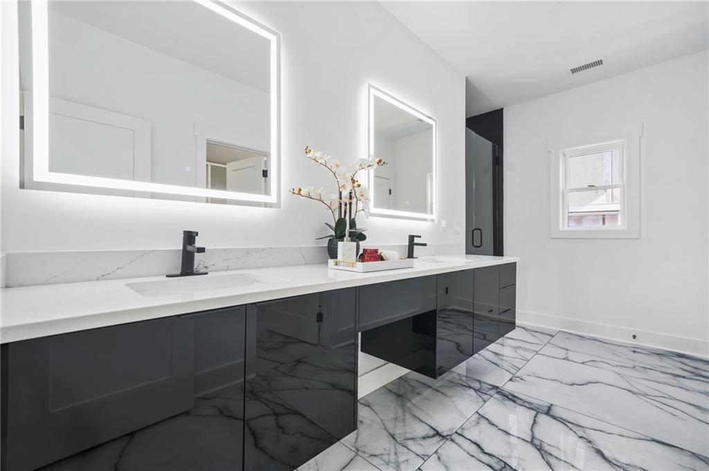 718 Cascade Avenue Southwest Atlanta, GA 30310 - Photo 3 of 37 a bathroom with a sink vanity and mirror