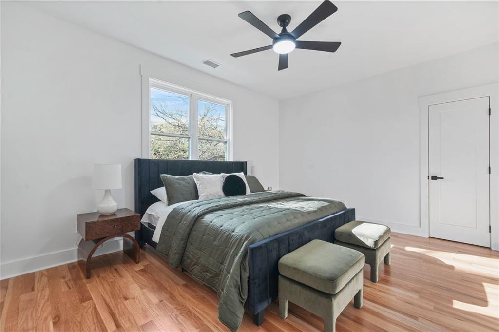 718 Cascade Avenue Southwest Atlanta, GA 30310 - Photo 6 of 37 a bed sitting in a bedroom next to a window with a chandelier