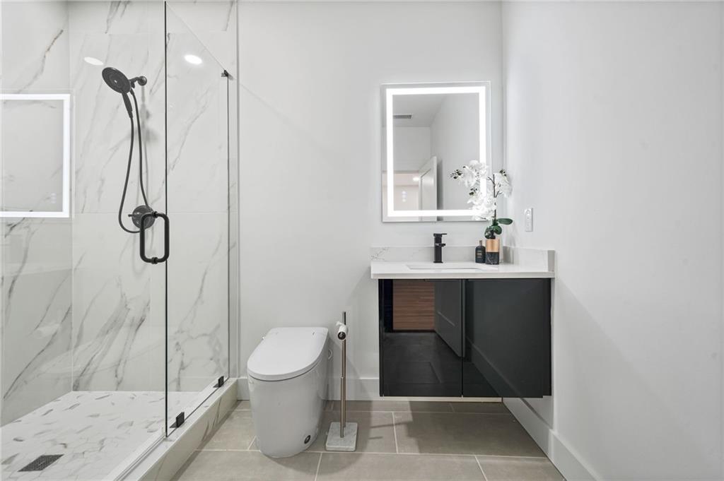 718 Cascade Avenue Southwest Atlanta, GA 30310 - Photo 7 of 37 a bathroom with a sink a toilet and shower