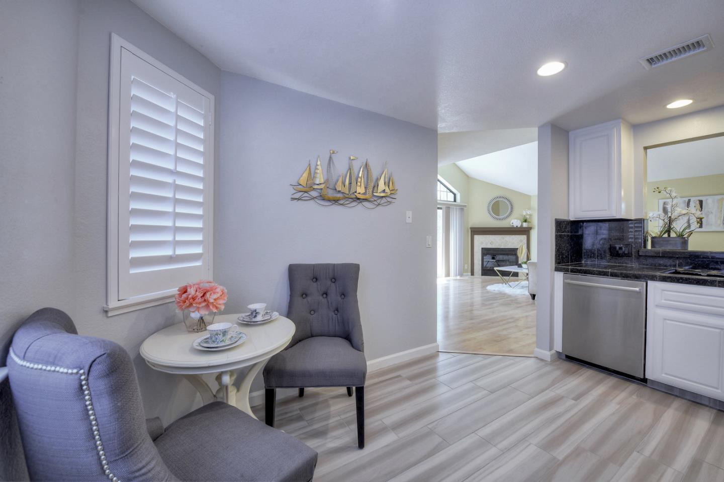 3156 Heather Ridge Drive San Jose, CA 95136 - Photo 13 of 29 a kitchen with stainless steel appliances kitchen island granite countertop a table chairs and a refrigerator