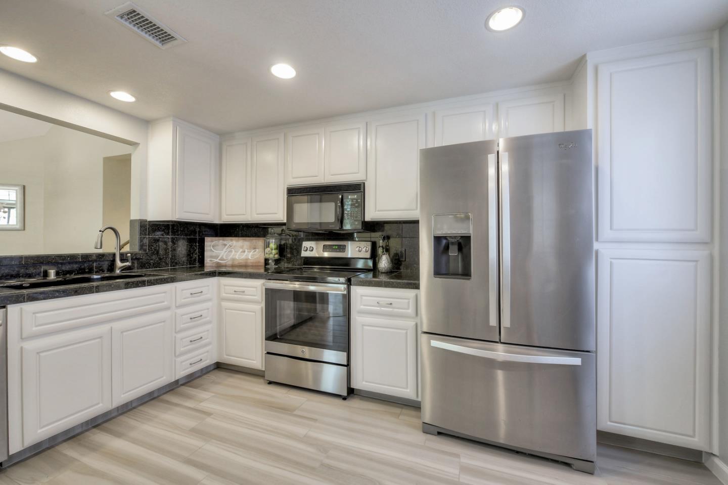 3156 Heather Ridge Drive San Jose, CA 95136 - Photo 14 of 29 a kitchen with stainless steel appliances a refrigerator sink and microwave