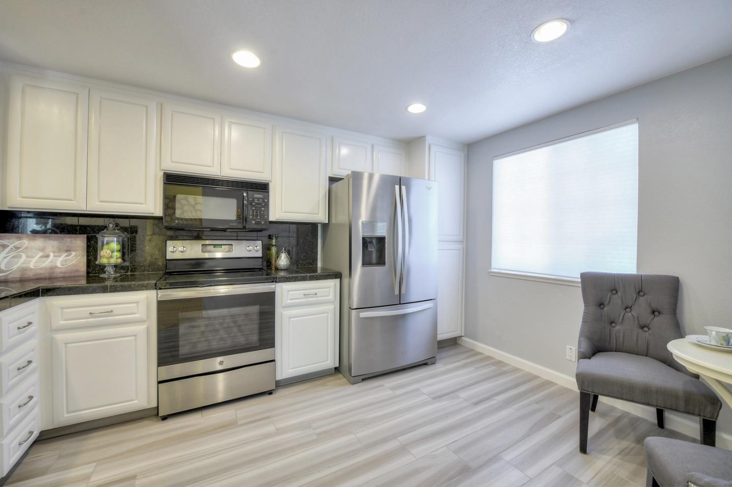 3156 Heather Ridge Drive San Jose, CA 95136 - Photo 15 of 29 a kitchen with stainless steel appliances granite countertop a stove a refrigerator and a microwave