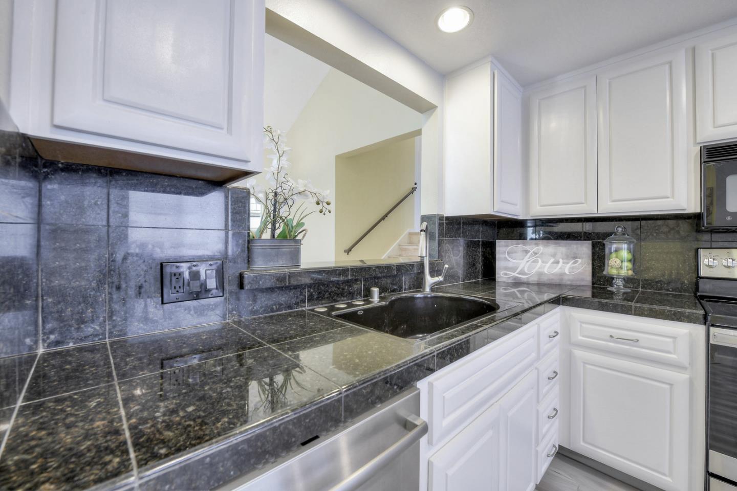3156 Heather Ridge Drive San Jose, CA 95136 - Photo 16 of 29 a kitchen with granite countertop a sink a stove and cabinets