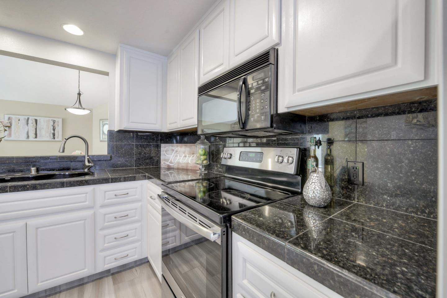 3156 Heather Ridge Drive San Jose, CA 95136 - Photo 17 of 29 a kitchen with stainless steel appliances granite countertop a sink stove and cabinets