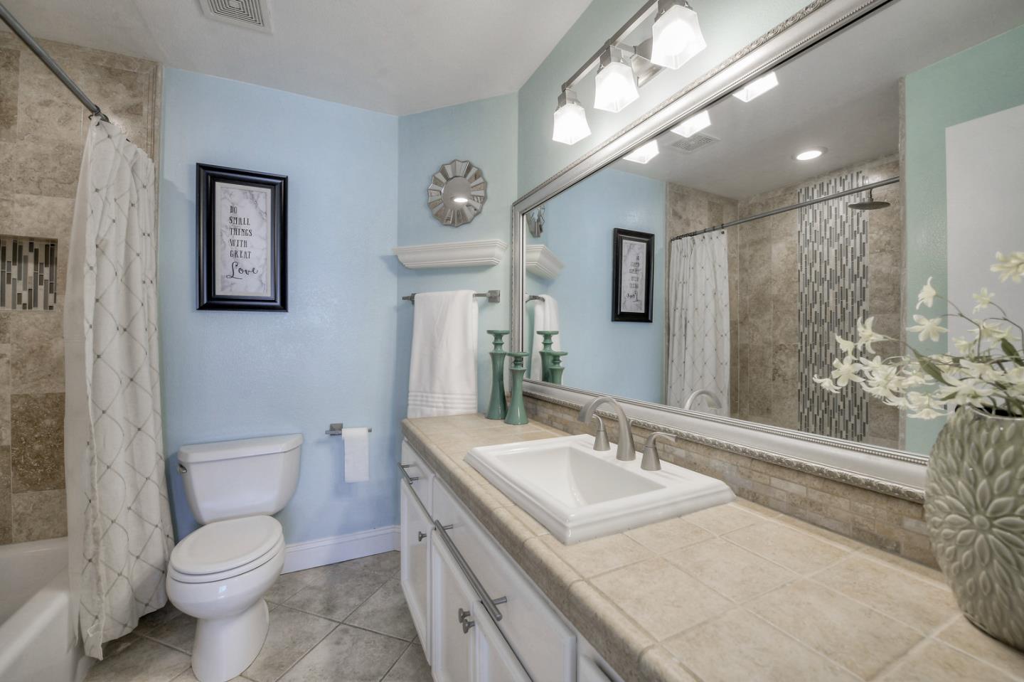3156 Heather Ridge Drive San Jose, CA 95136 - Photo 22 of 29 a bathroom with a granite countertop sink a toilet and a mirror