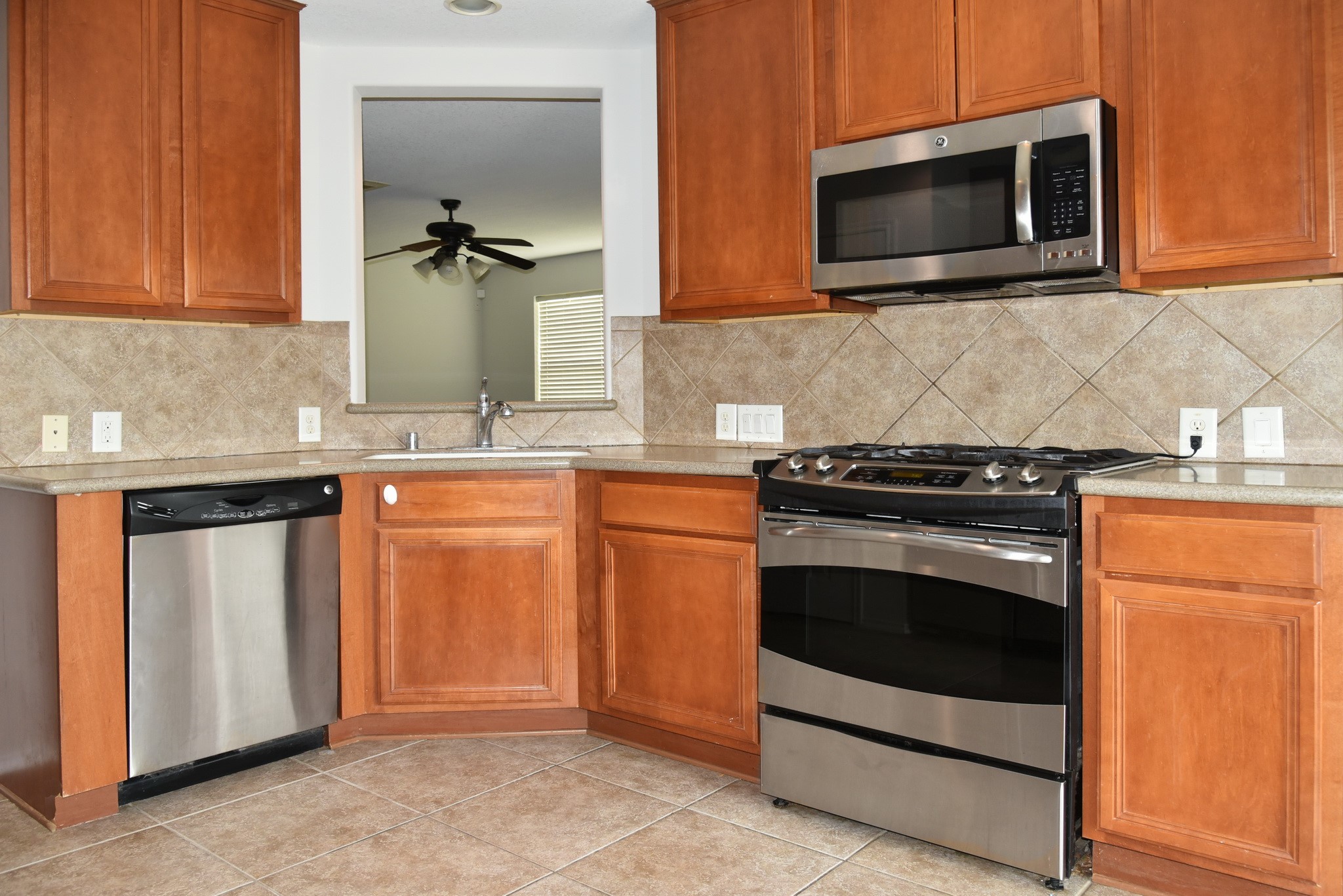 13600 Breton Ridge Street, Unit 20B Houston, TX 77070 - Photo 16 of 32 a kitchen with stainless steel appliances granite countertop a stove microwave and cabinets