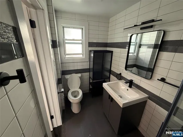 a bathroom with a sink toilet and mirror
