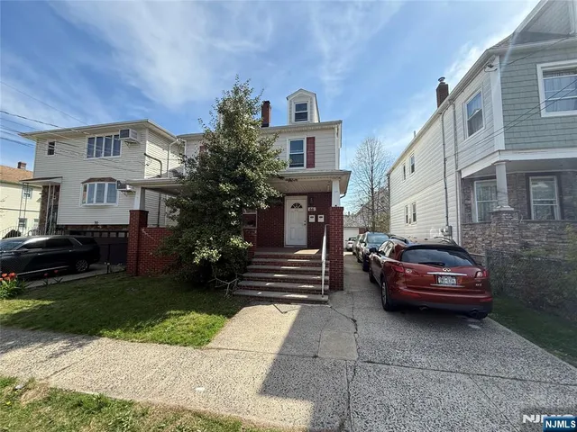 a car parked in front of a white house