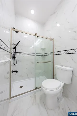 a bathroom with a toilet and a shower