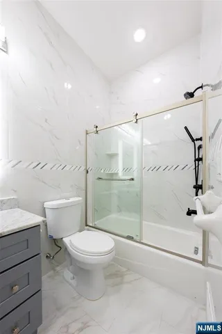 a bathroom with a toilet sink and a shower