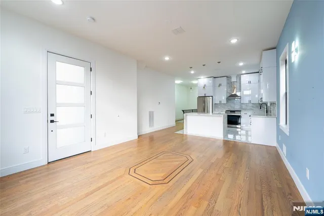 a view of a kitchen with white cabinets