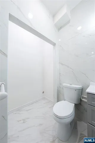 a bathroom with a toilet a sink and shower