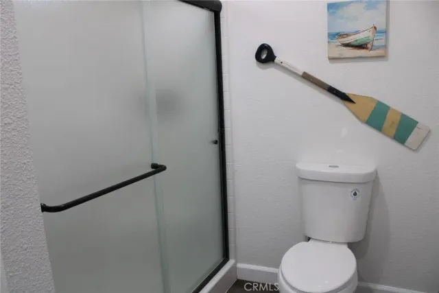 a bathroom with a toilet and a shower